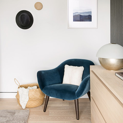 modern bedroom featuring a poliform mad chair in blue velvet