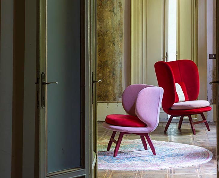 traditional room featuring modern moroso ayub chairs in red and lavender velvet