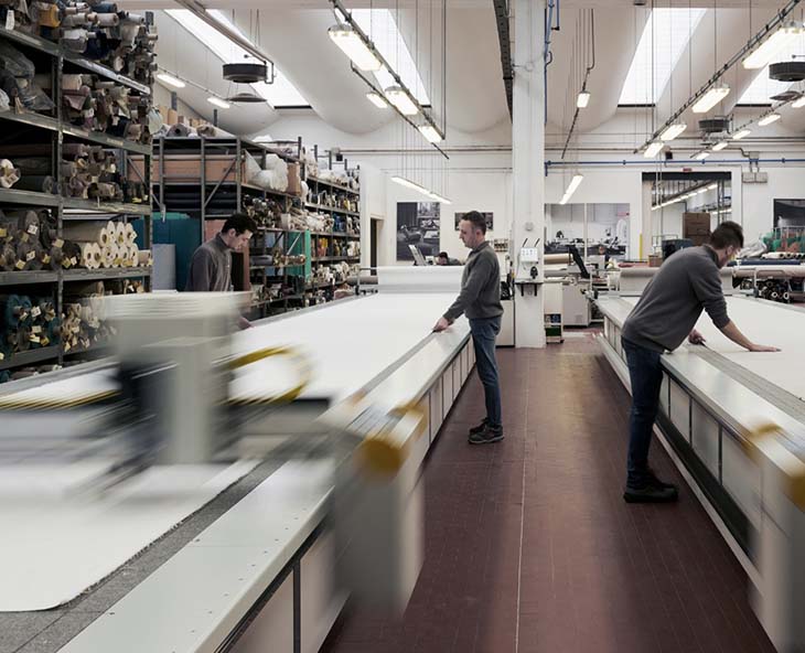 craftsmen working in the flexform factory in italy