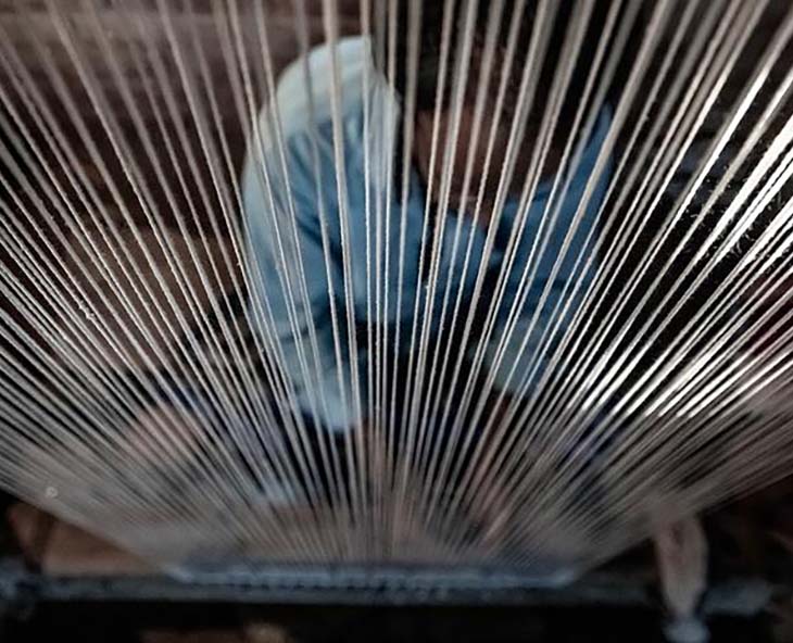 rugmaker knotting a kymo rug