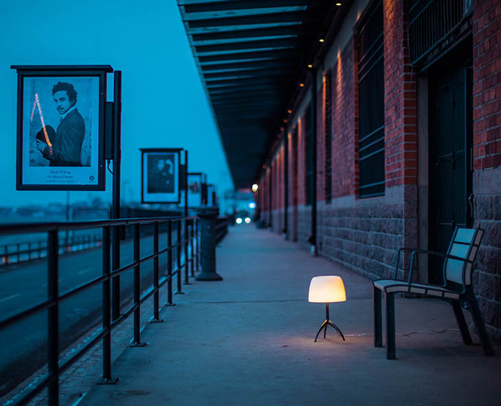 outdoor train platform featruing foscarini lumiere table lamp