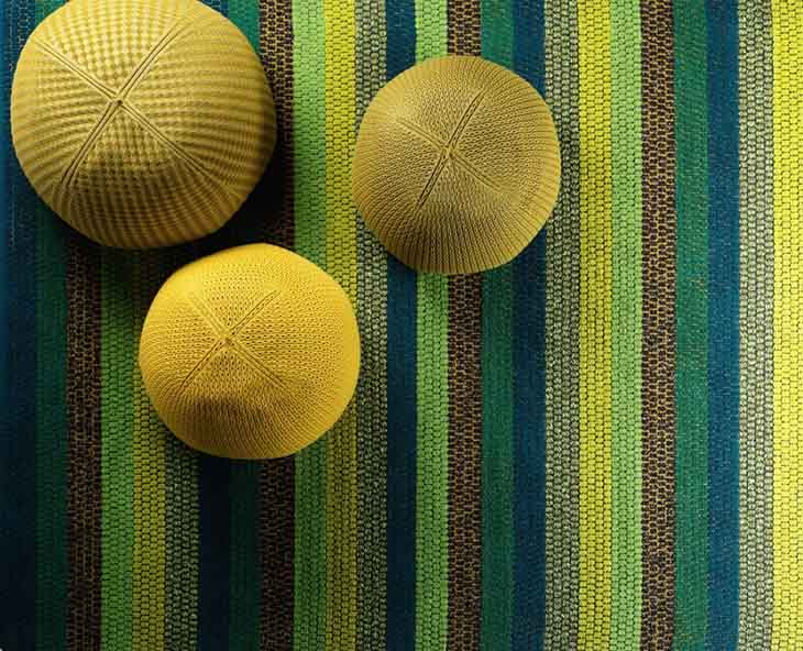 detail of kasthall happy rug in green, yellow, and blue stripes