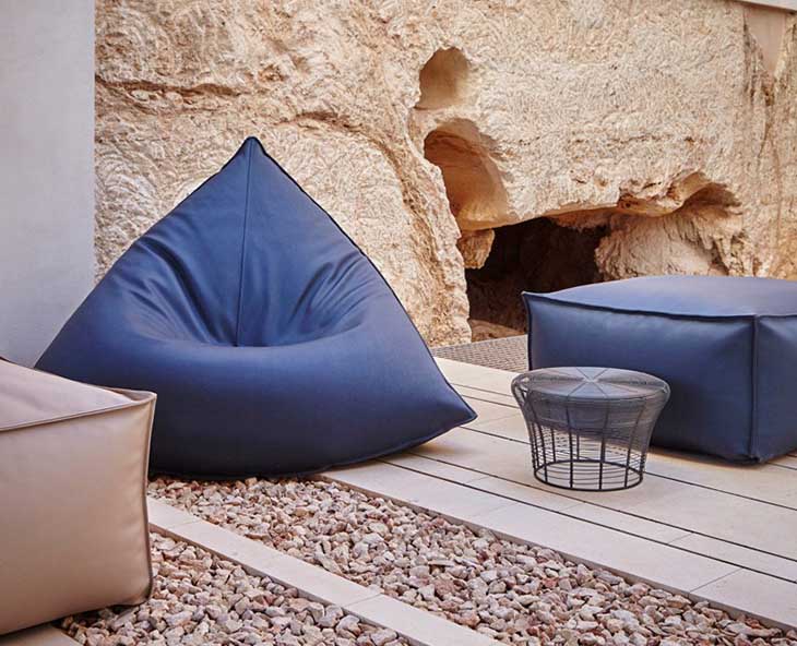 outdoor patio featuring gandia blasco sail armchair and poufs