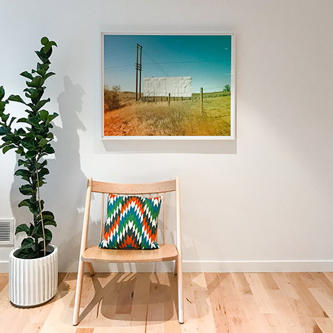 art by jamie kripke hanging in a sparse room