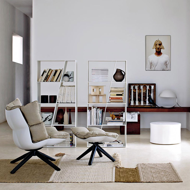 modern living room featuring b&b italia husk armchair and ottoman with wood base