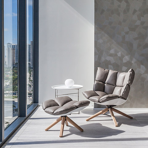bright interior space featuring b&b italia husk armchair and ottoman with wood base