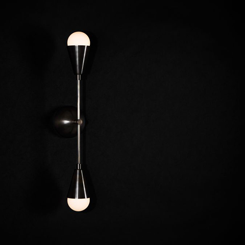 apparatus triad 2 sconce on a black background