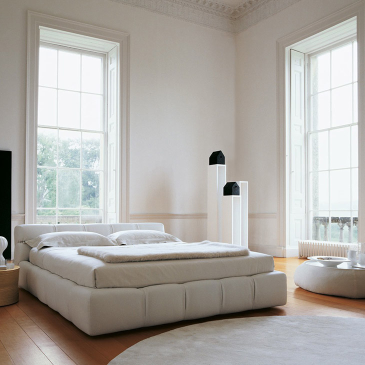 modern bedroom featuring a b&b italia fat fat ottoman