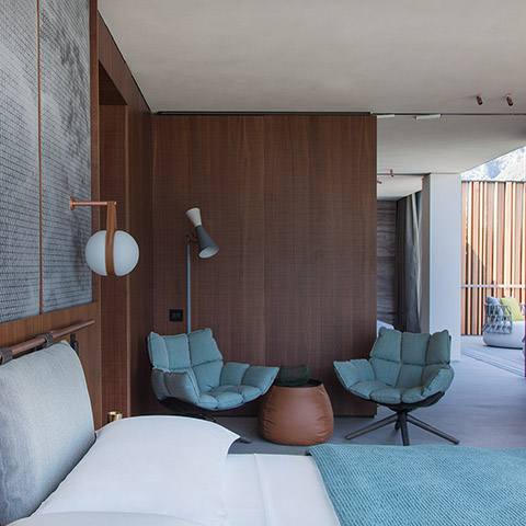 modern bedroom featuring a b&b italia lady fat ottoman