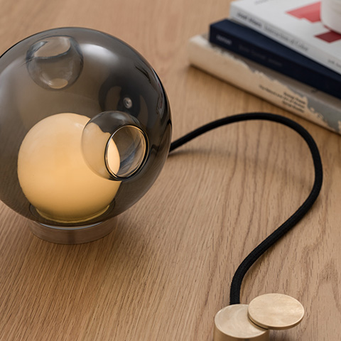 interior space featuring bocci 28t table lamp on wood desk