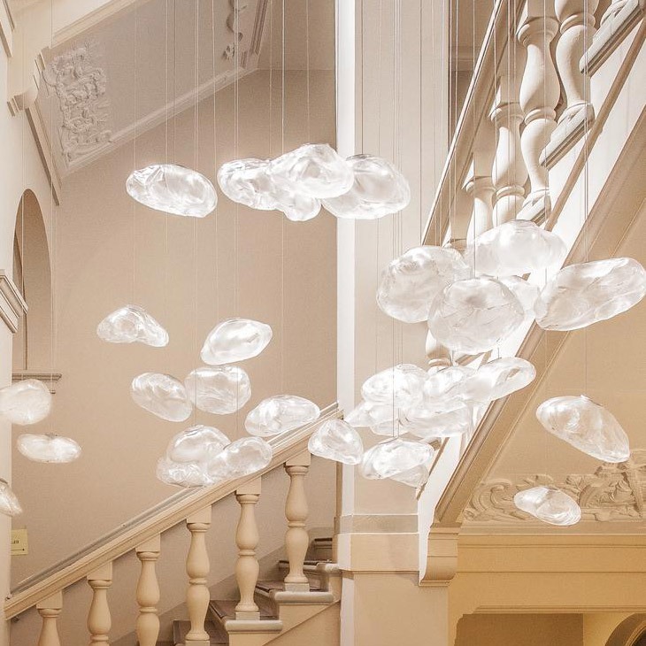stairwell featuring multiple bocci 73 pendant lights