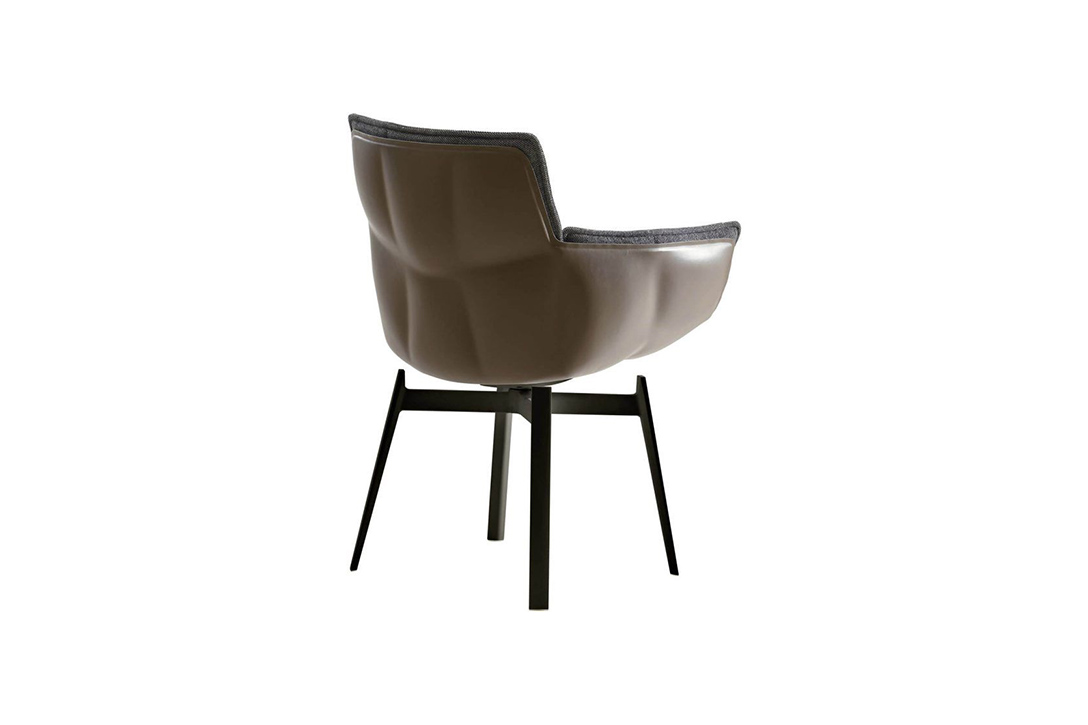 back of a b&b italia husk chair with metal base on a white background