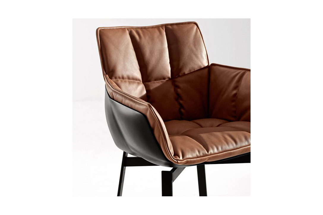 b&b italia husk chair with metal base on a grey background
