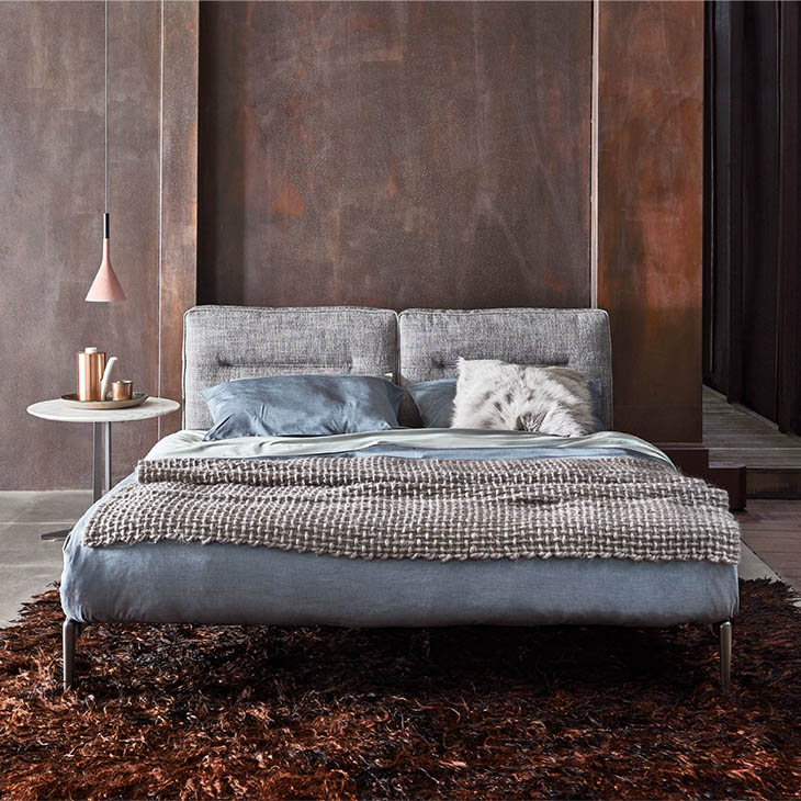 modern bedroom featuring a flexform fly side table