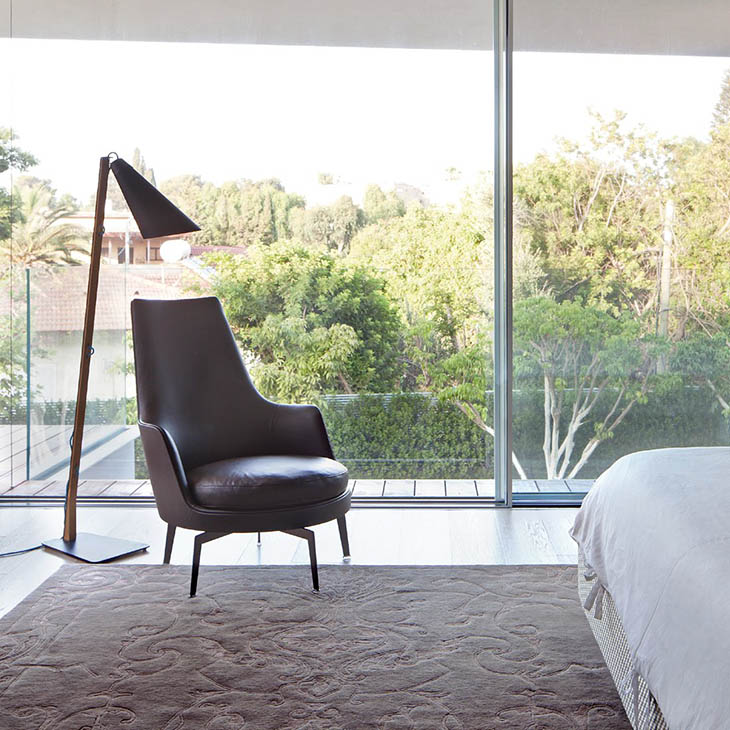 modern bedroom featuring a flexform guscioalto armchair