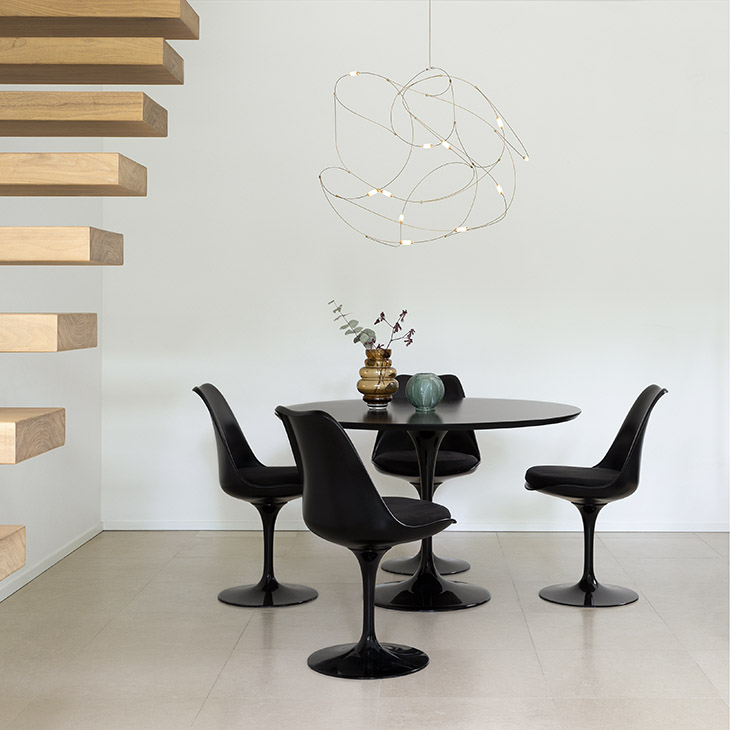 modern dining room featuring moooi flock of light pendant