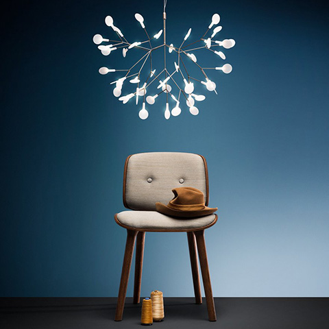 moooi heracleum II suspended pendant light hanging above a stool