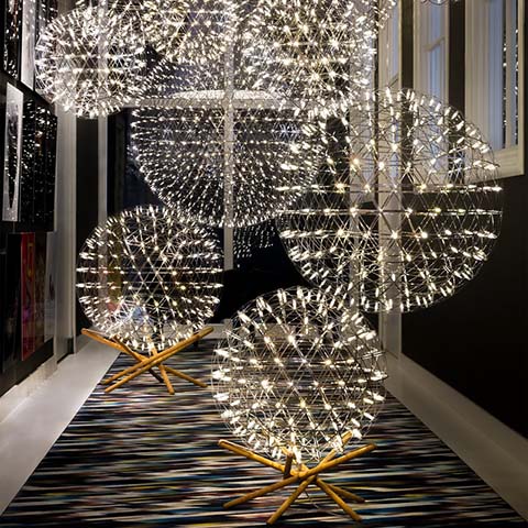 moooi raimond tensegrity floor lamps and pendants in a hallway