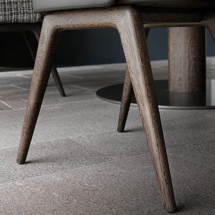 close up of solid sucupira legs on a minotti reeves dining chairs