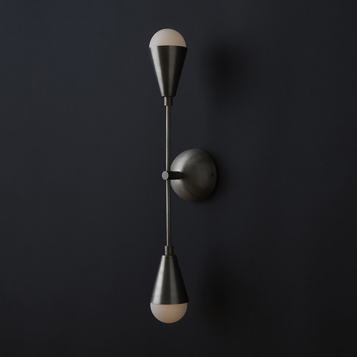 apparatus triad 2 sconce on a black background